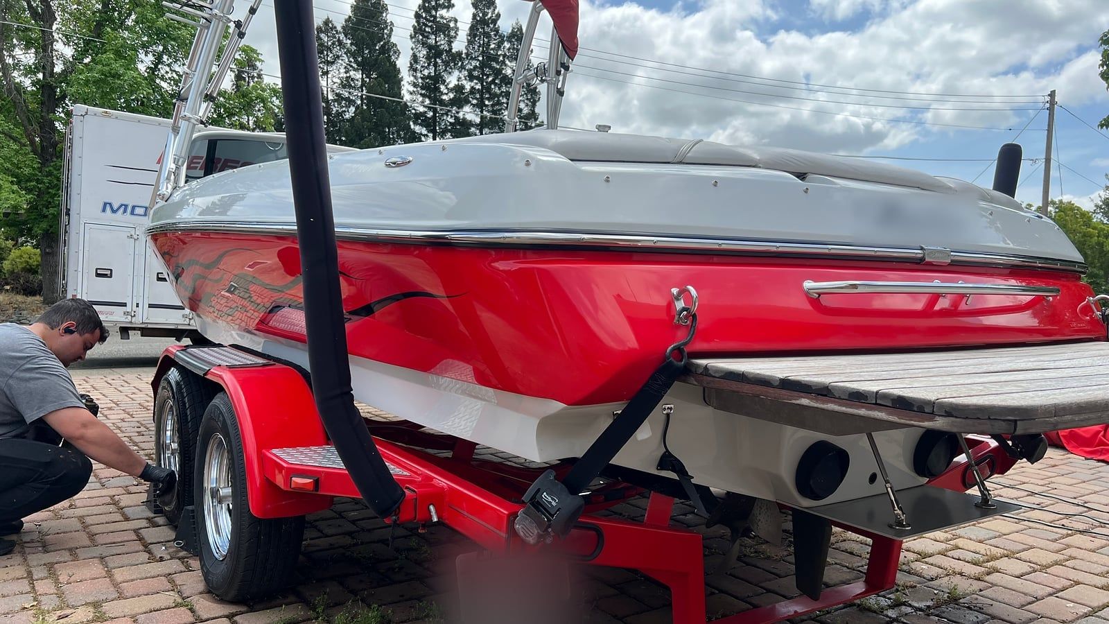Red wakeboard boat on its trailer