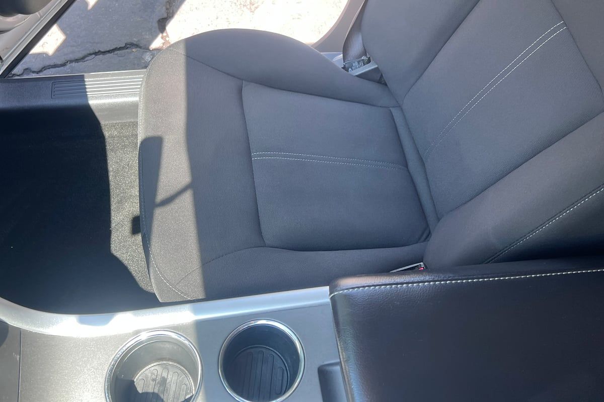 Front cloth seat and center console of a silver Ford SUV