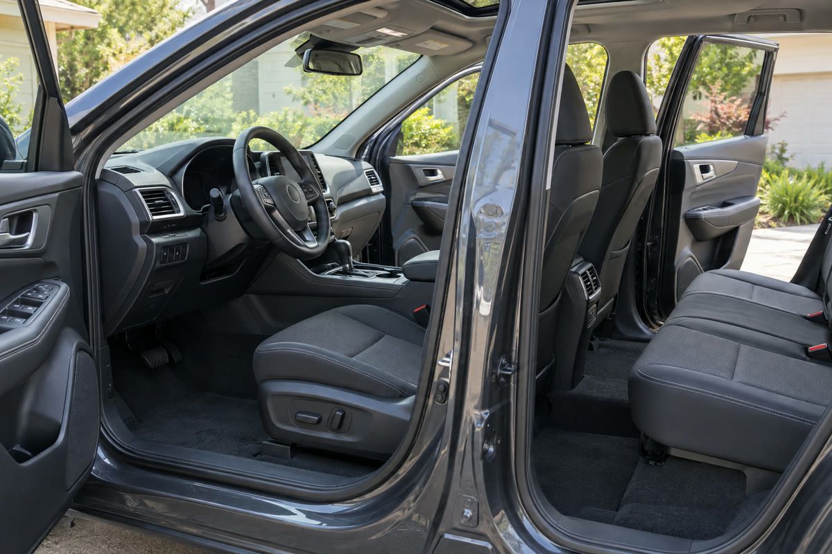 A clean gray SUV cabin with the front and rear doors open