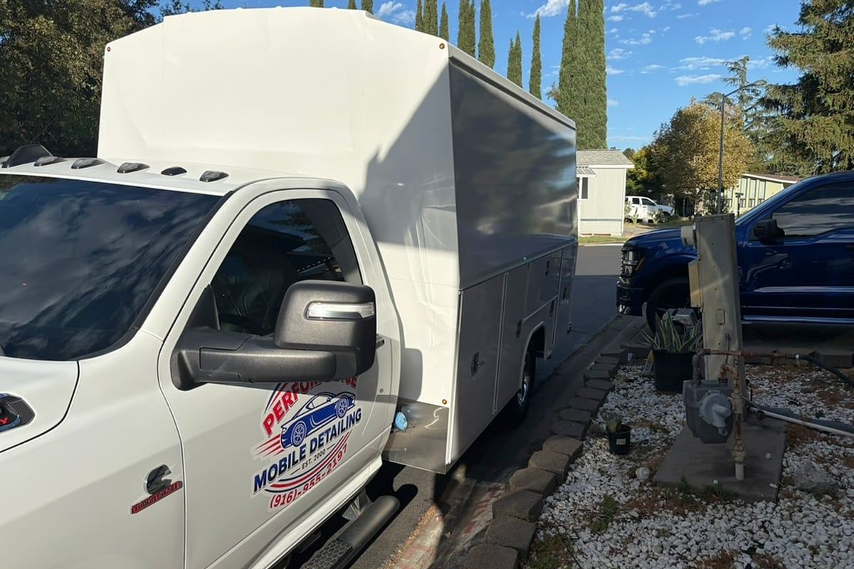 Service truck cab and utility body with the Performance Mobile Detailing door logo