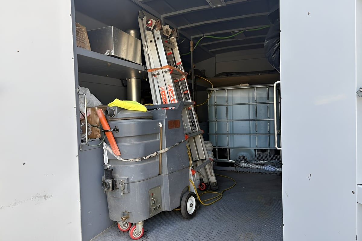 Open cargo bay of the service truck with the extractor, shelving and water tank